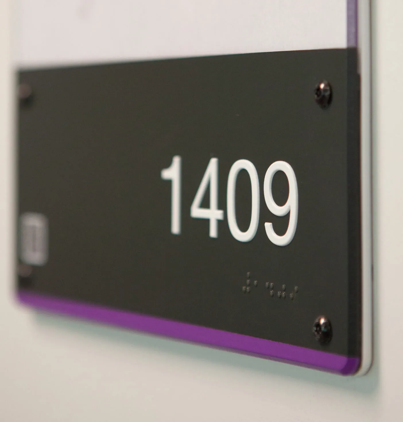 Room number 1409 sign with braille.