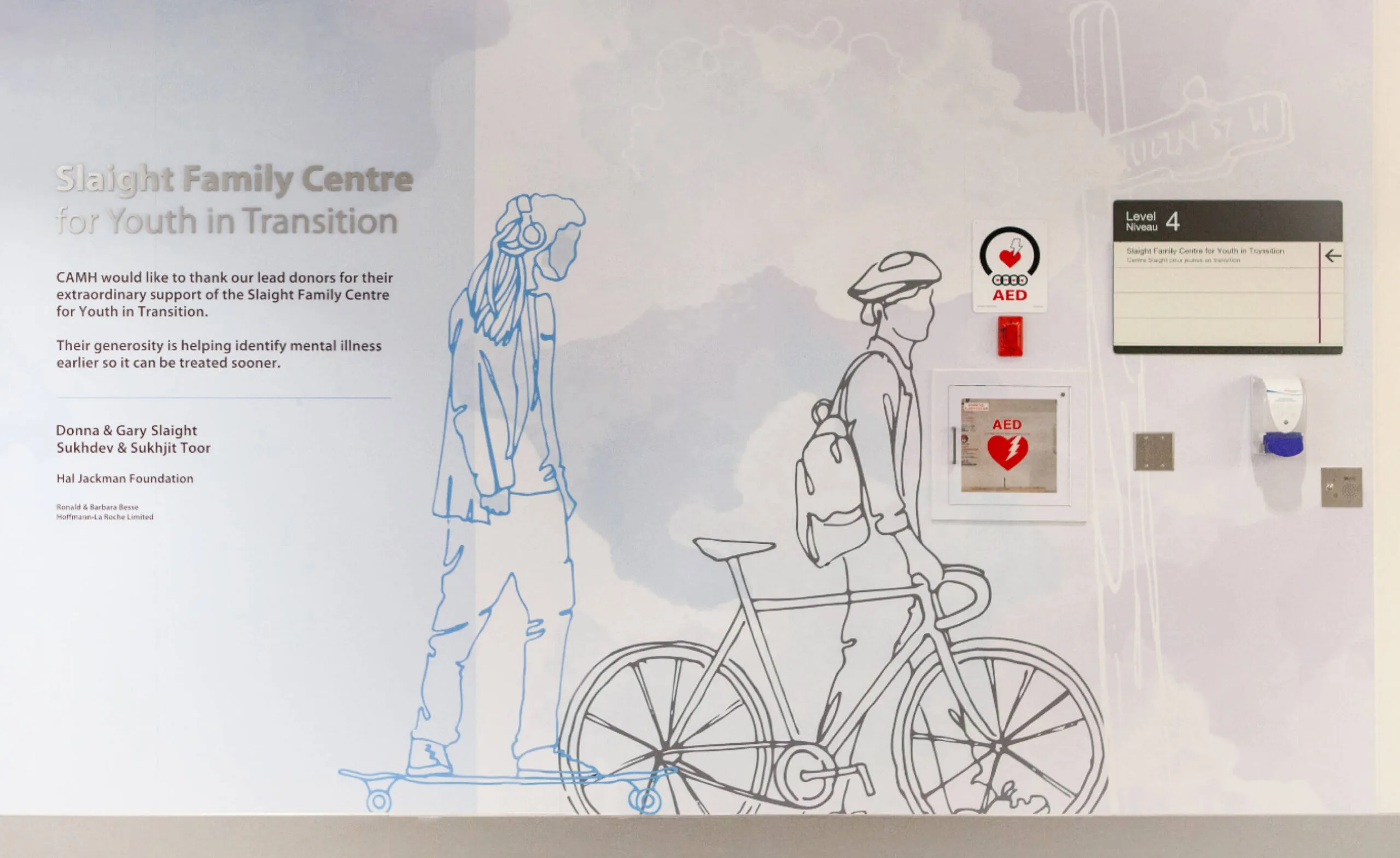 Slaight Family Centre for Youth in Transition mural with donor recognition and AED signs.
