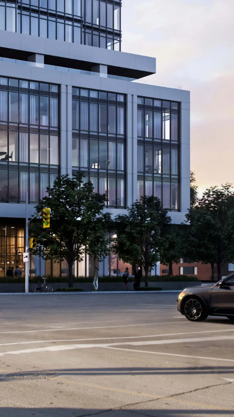 Modern apartment building with cars and trees on a street.