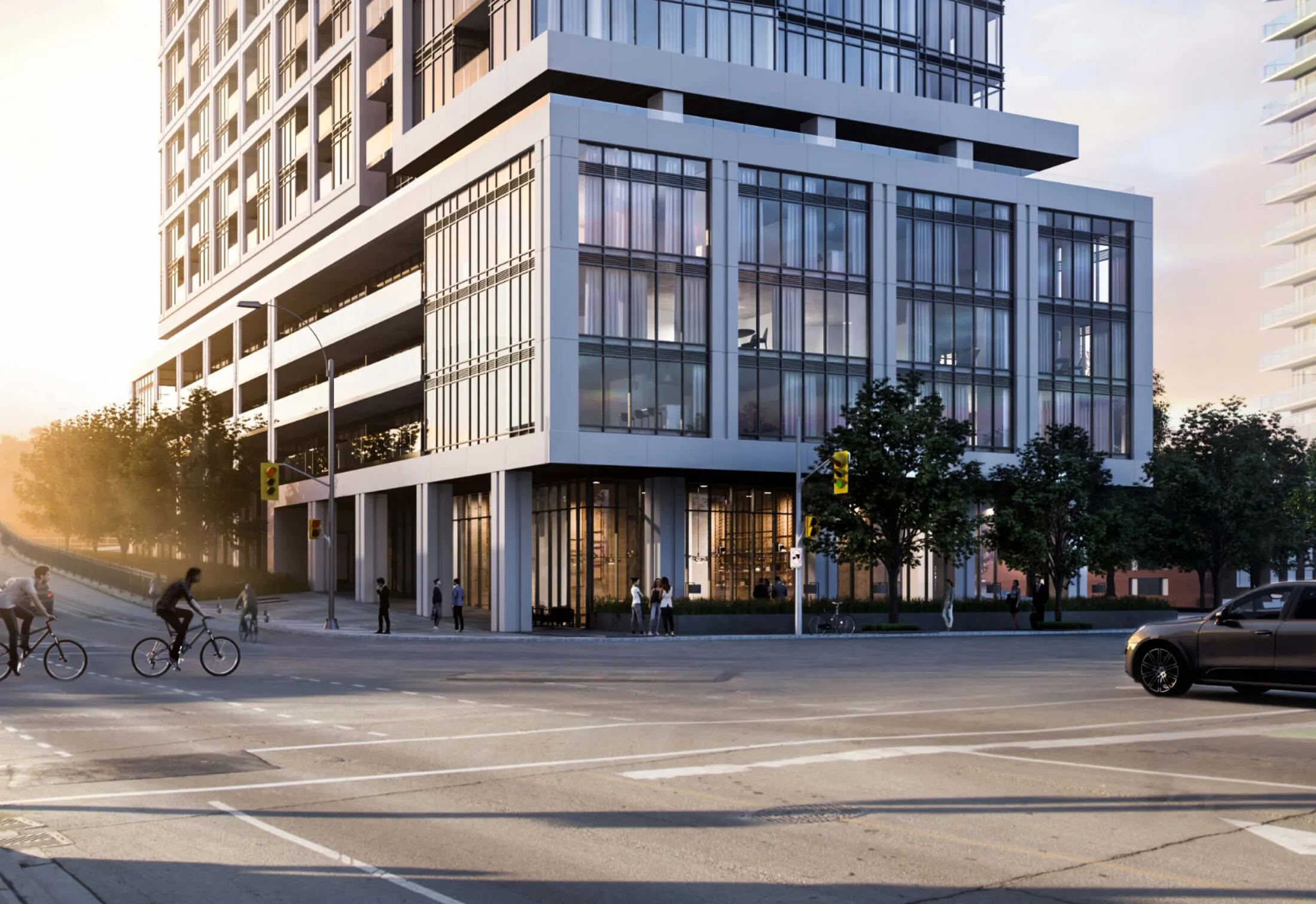 Modern apartment building with people and cars on a sunny street.