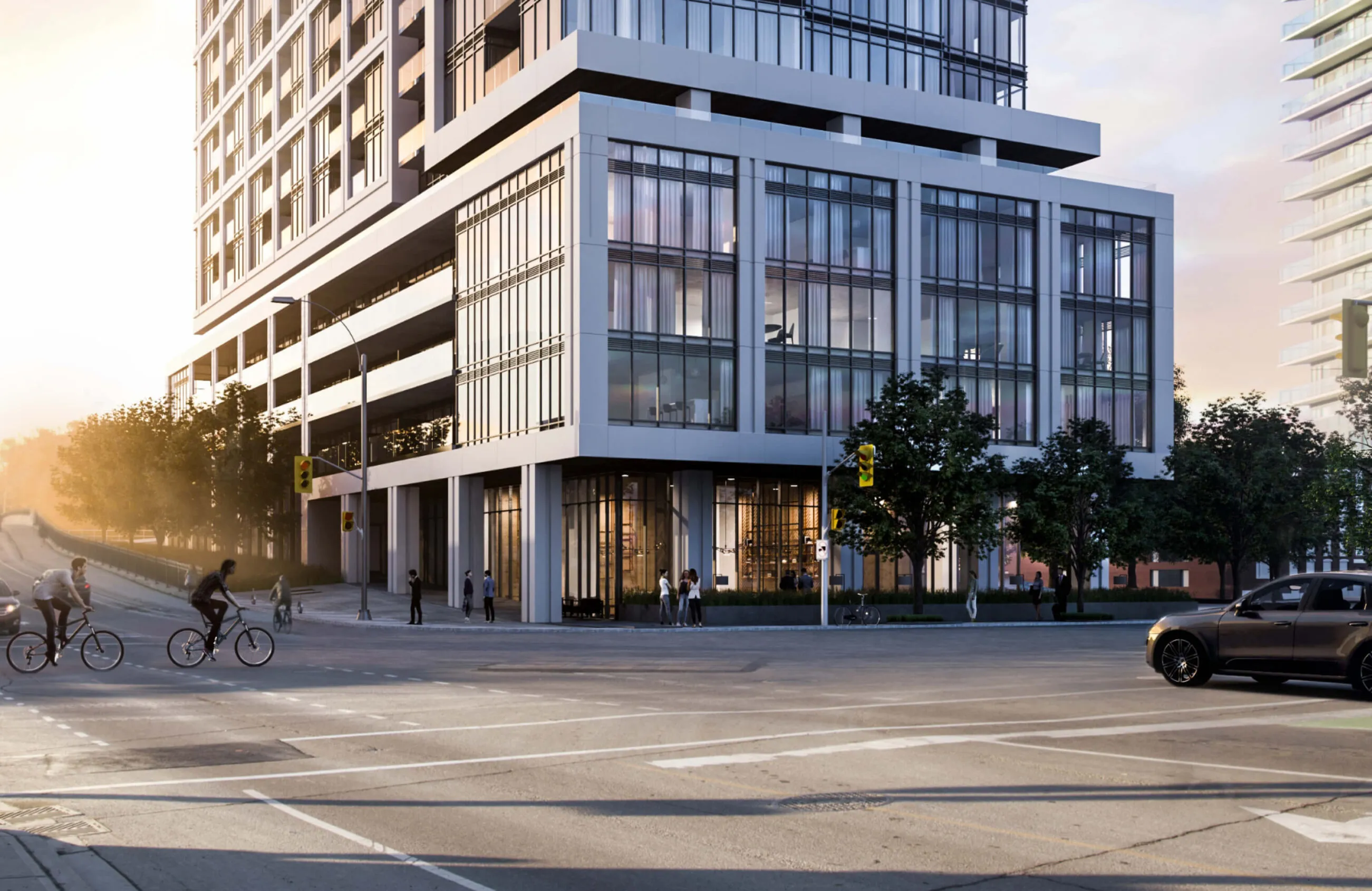 Modern apartment building with people and cars on a sunny street.