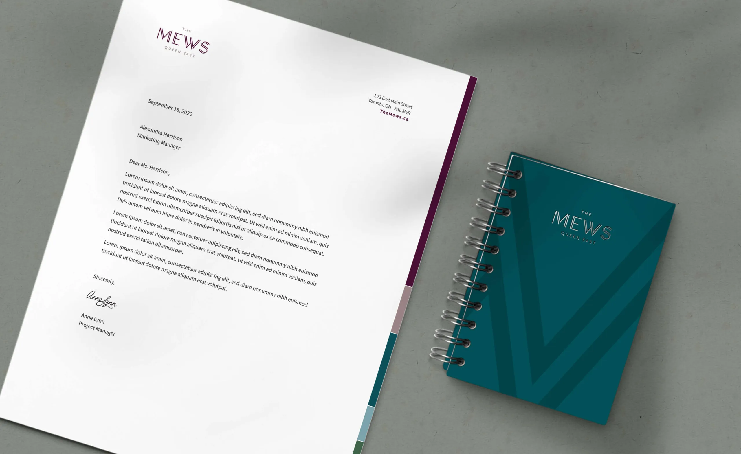 Letterhead and notebook with The Mews Queen East logo