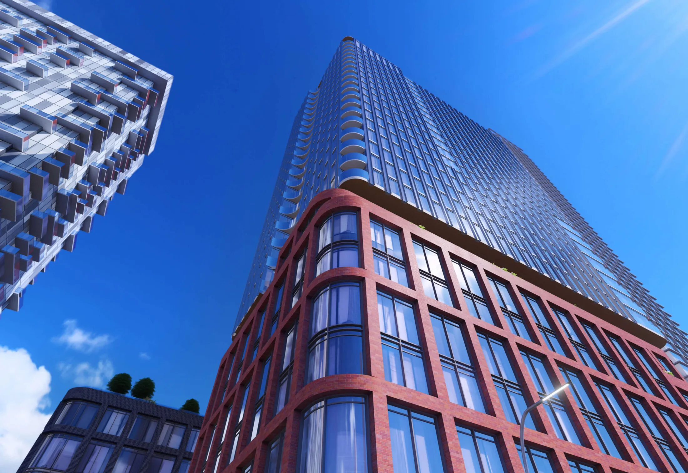 Modern glass and brick skyscrapers against a bright blue sky.