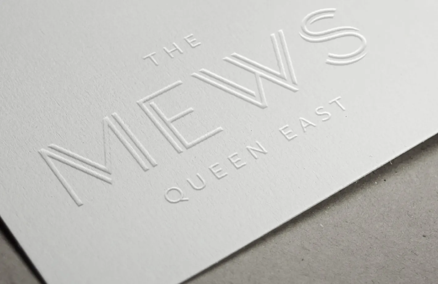 The Mews Queen East logo