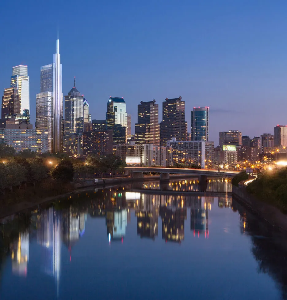 Philadelphia skyline at dusk with reflections in the river.
