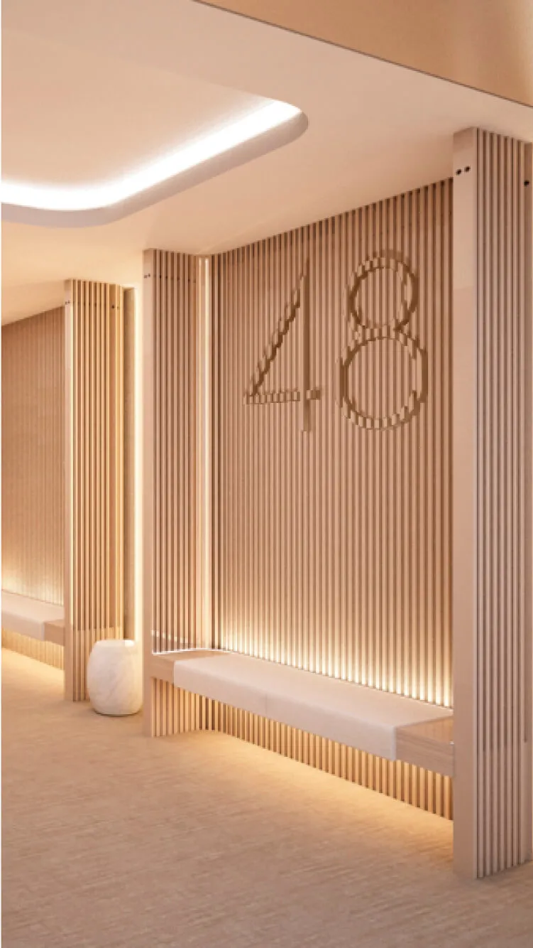 Modern hallway with slatted wood walls, bench seating, and subtle lighting.