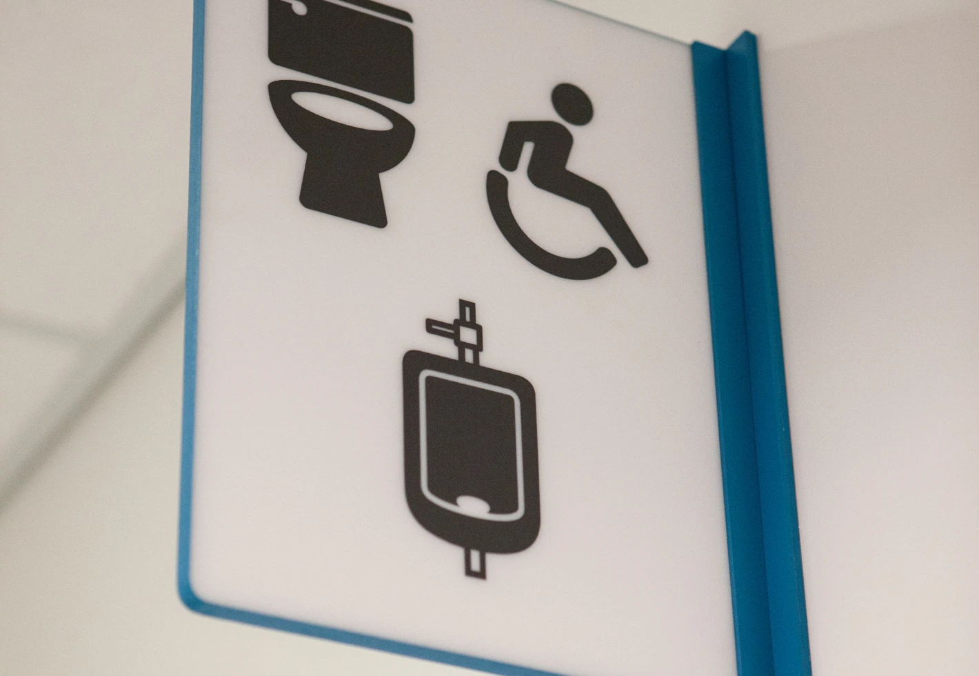 Restroom signs: toilet, accessible, and urinal icons.