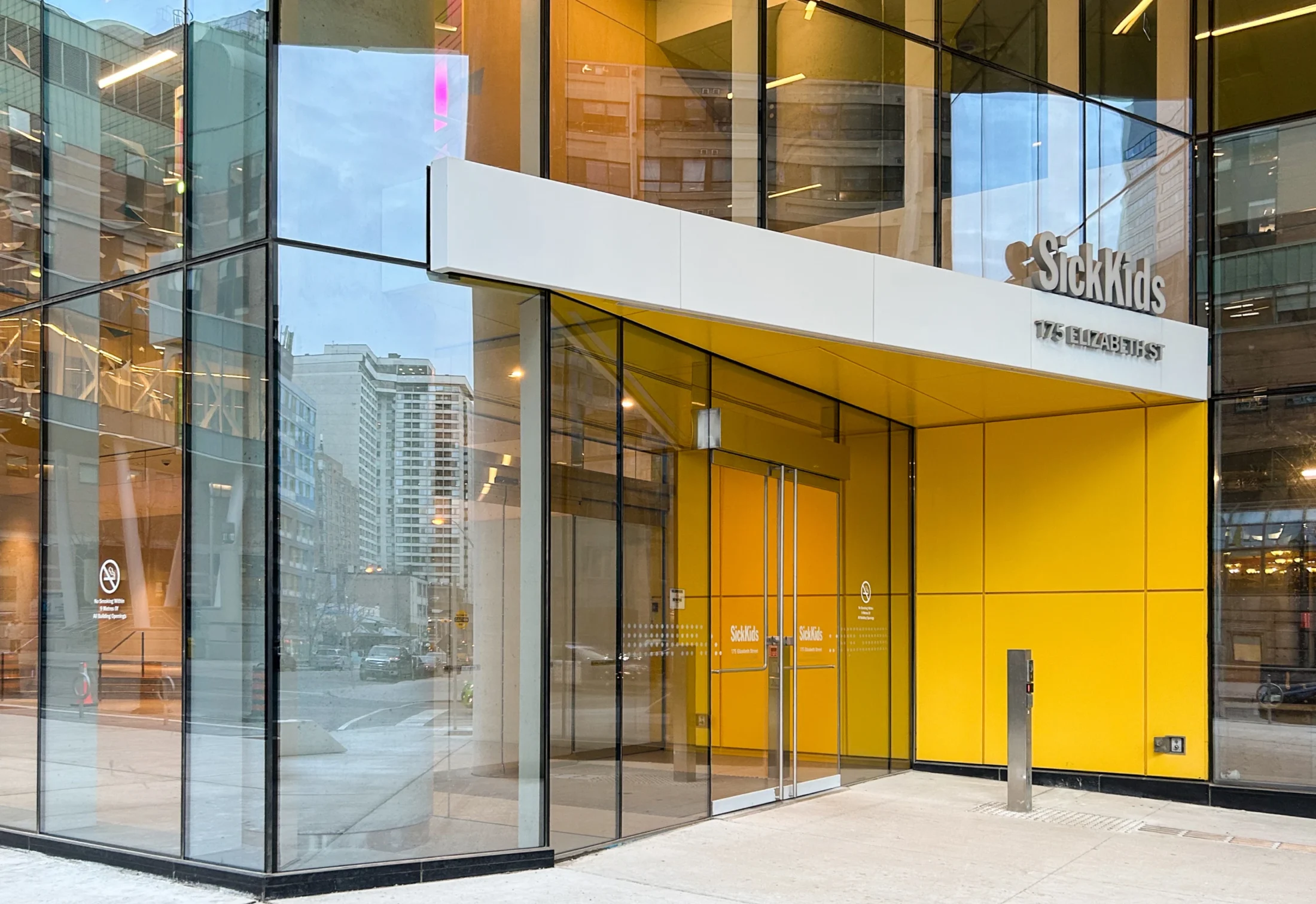 SickKids hospital entrance at 175 Elizabeth Street with yellow accents.
