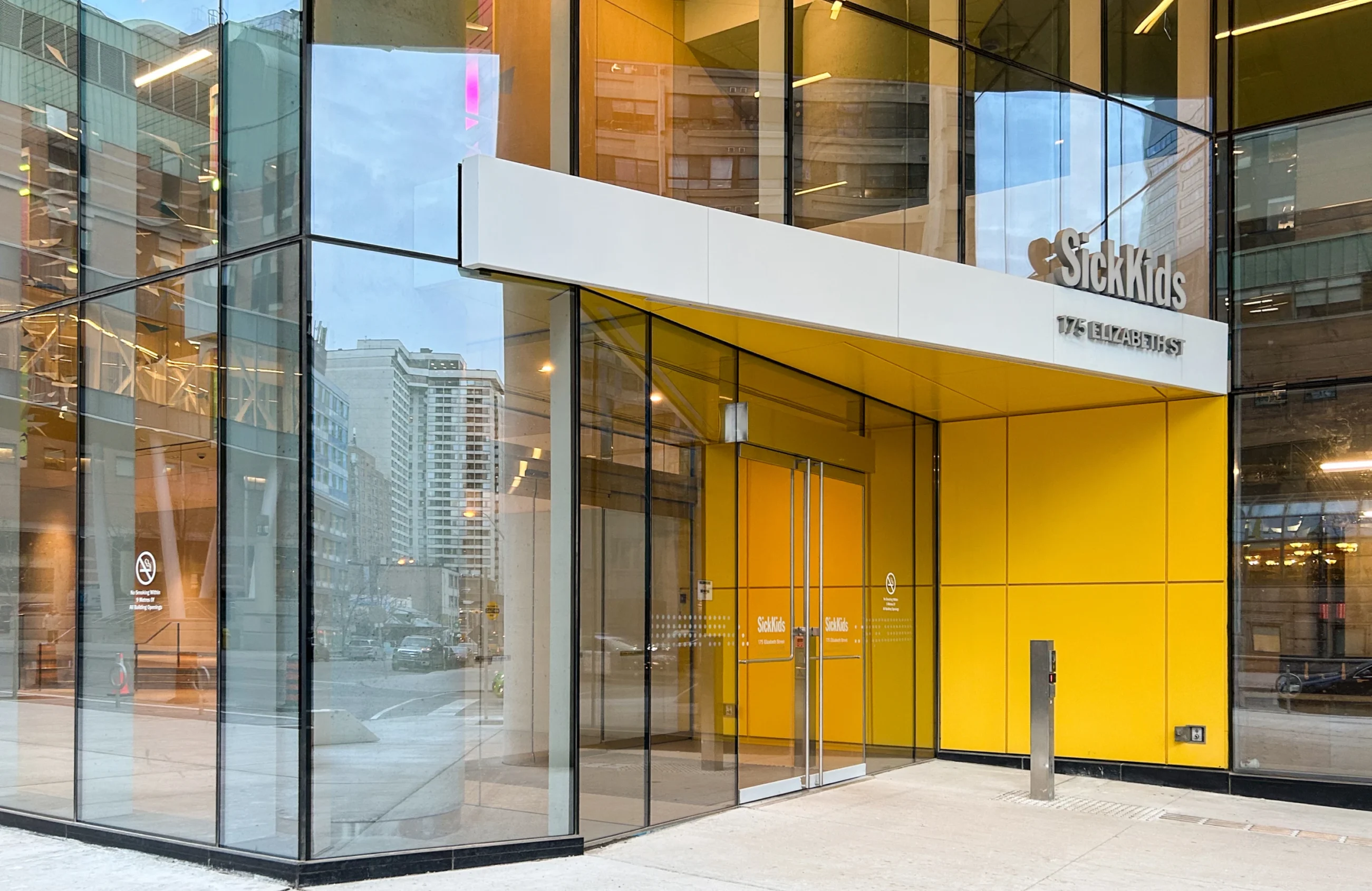 SickKids hospital entrance at 175 Elizabeth Street with yellow accents.