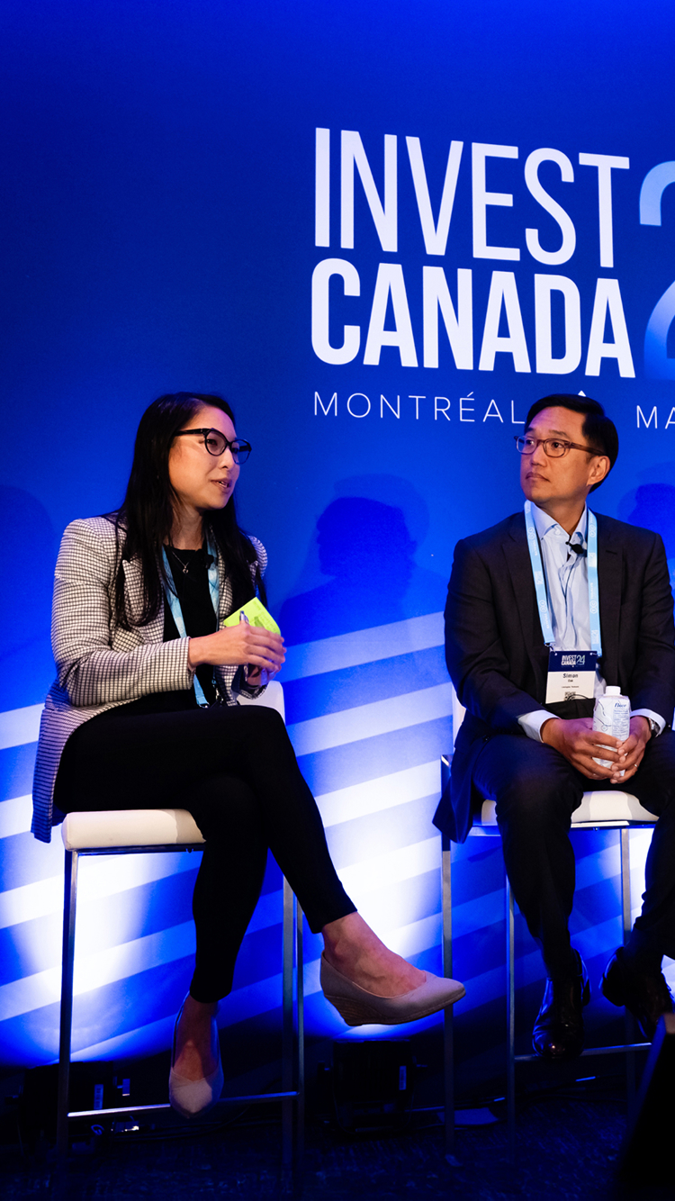 Two speakers on a stage at Invest Canada 2024.
